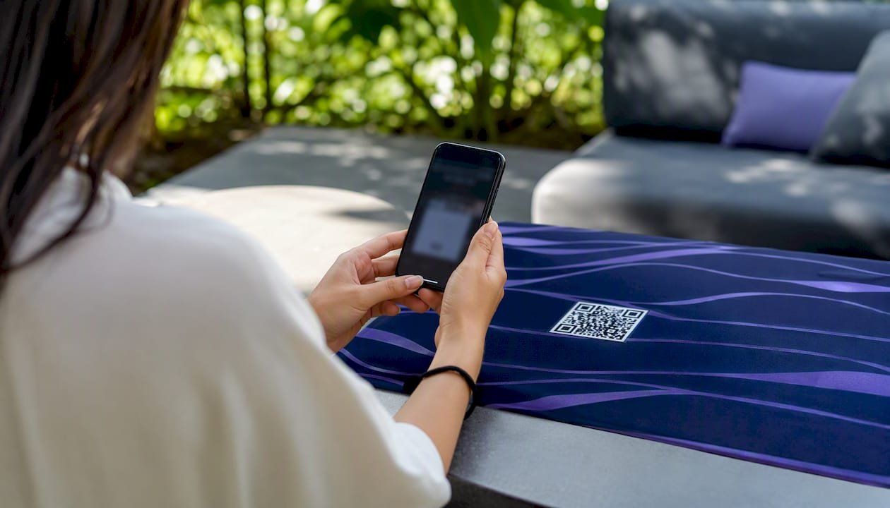 Person scanning a guest Wi-Fi QR code on a phone