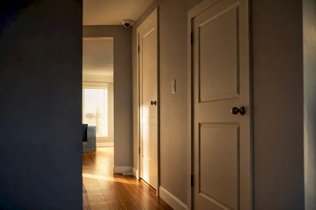 Indoor security camera mounted high in a hallway corner